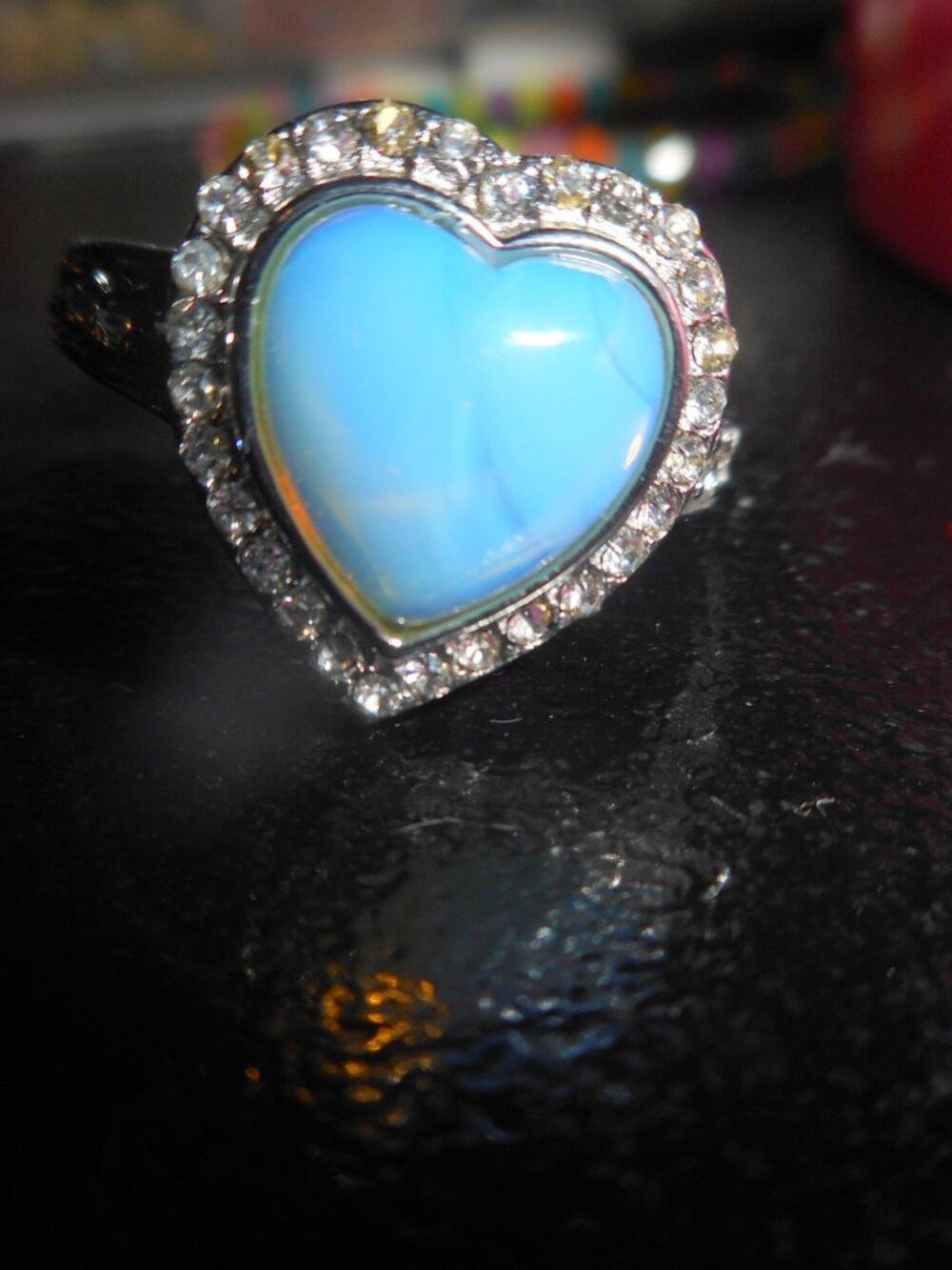 opal heart ring - with white stones all around the heart and 4 down each side. 9
